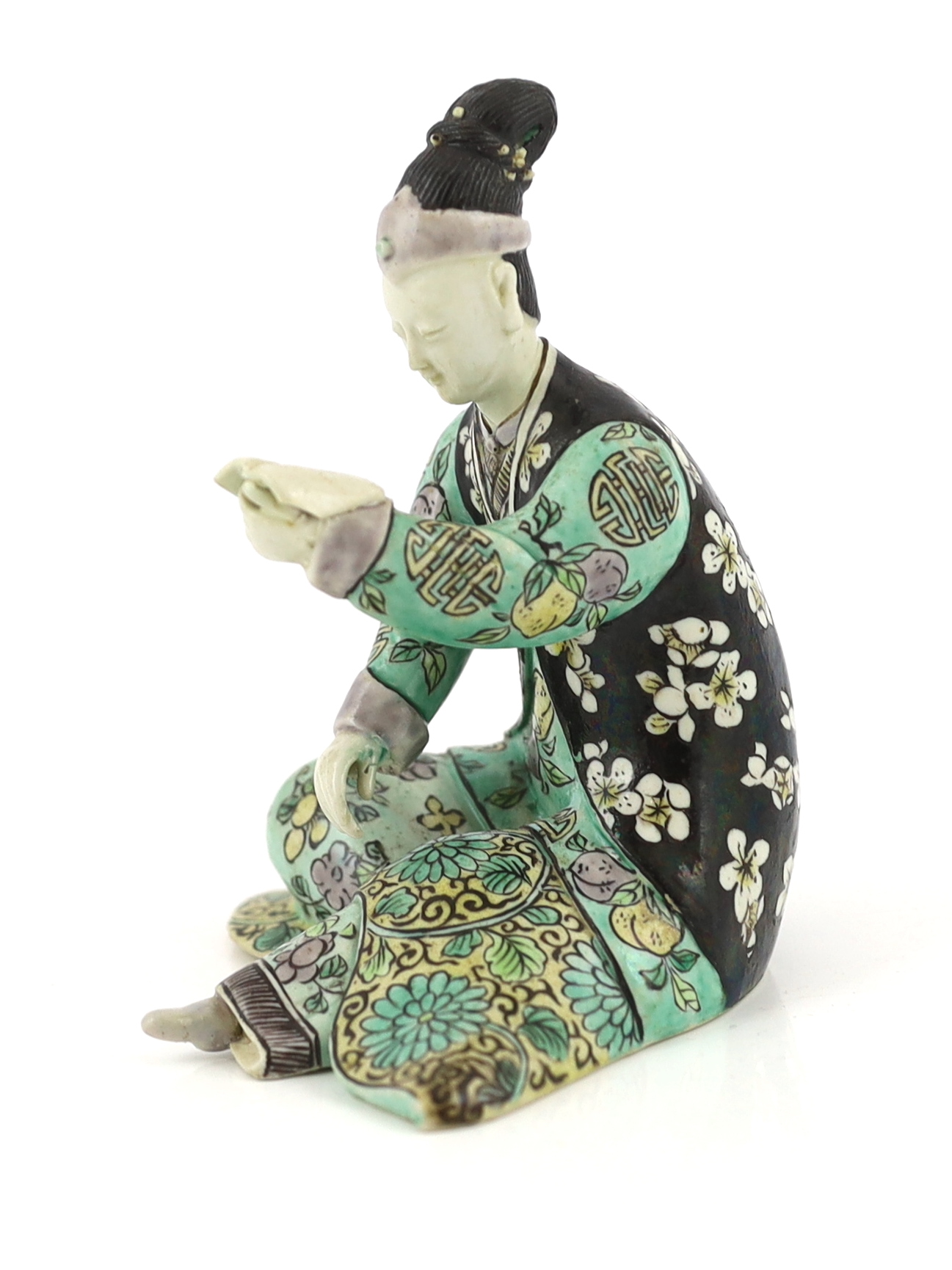A Chinese susancai figure of a seated woman, Kangxi period, some restoration